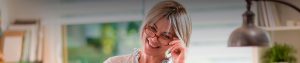 smiling woman removing eye glasses